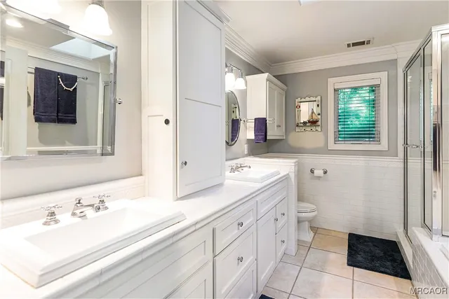 a bathroom with a sink toilet and mirror