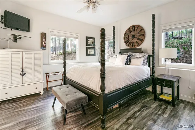 a bed sitting in a bedroom next to a window