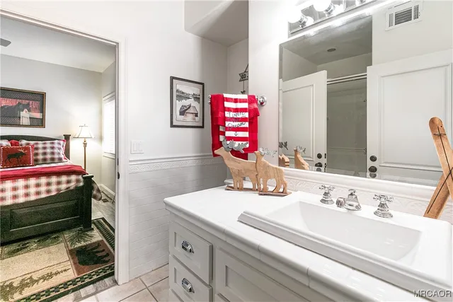 a bathroom with a sink double vanity and a mirror
