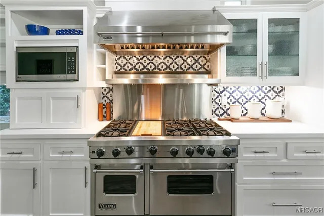 a stove top oven sitting inside of a kitchen