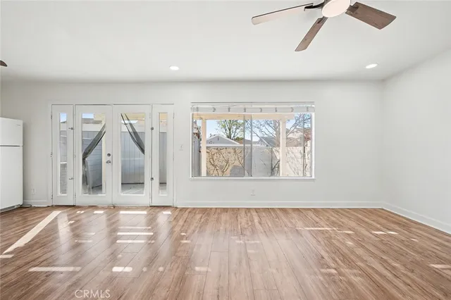 a view of a room with wooden floor and window