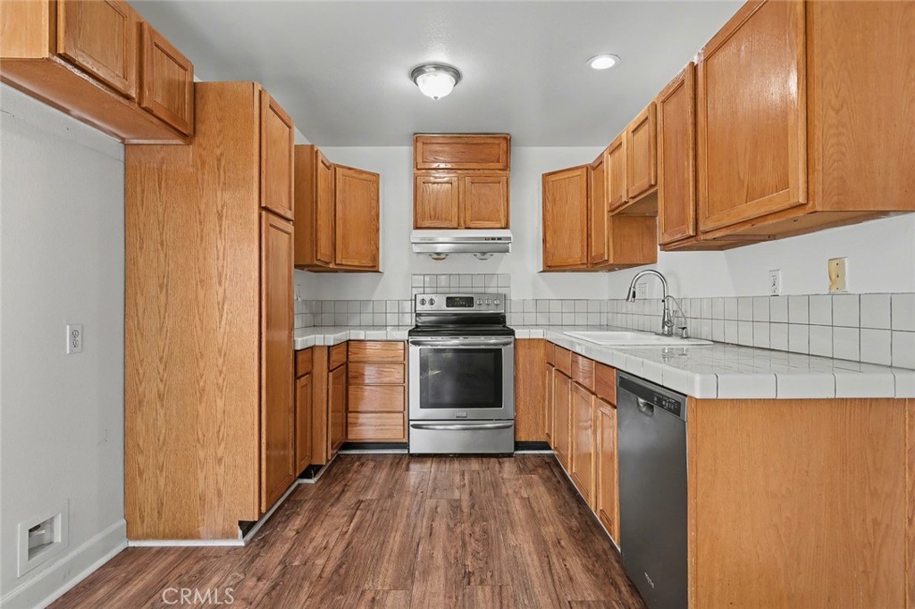 23517 Twin Spring Lane Diamond Bar, CA 91765 - Photo 16 of 40 a kitchen with stainless steel appliances granite countertop a stove a sink and a refrigerator