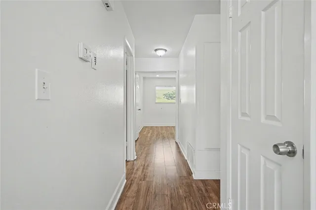 a view of a hallway with wooden floor