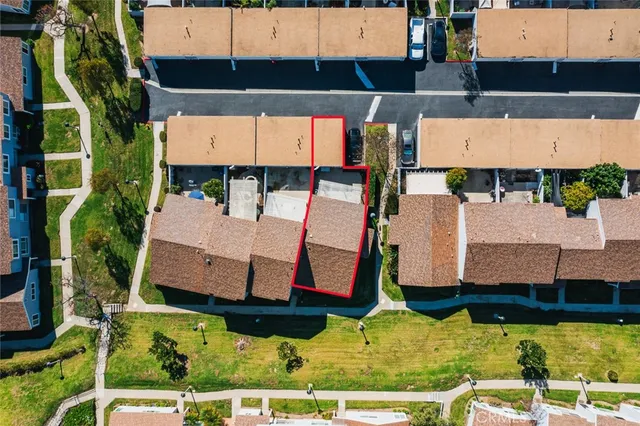 an aerial view of residential houses with outdoor space