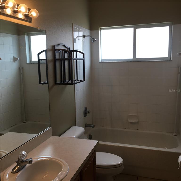 18047 Java Isle Drive Tampa, FL 33647 - Photo 18 of 21 a bathroom with a sink toilet and shower