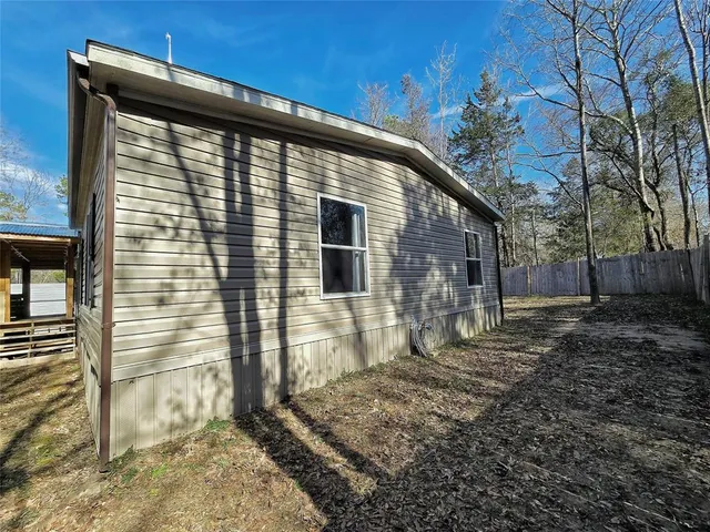 a side view of a house with a yard