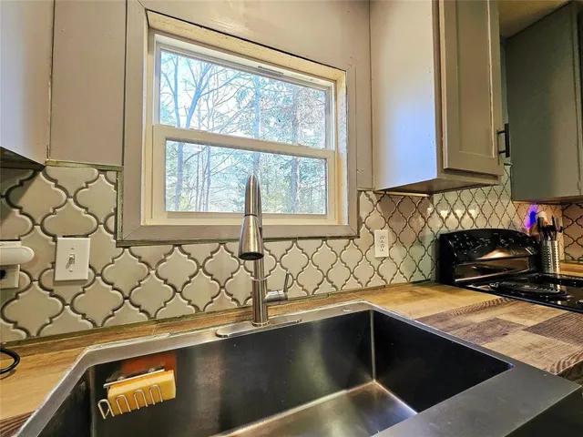a kitchen with a sink and a window