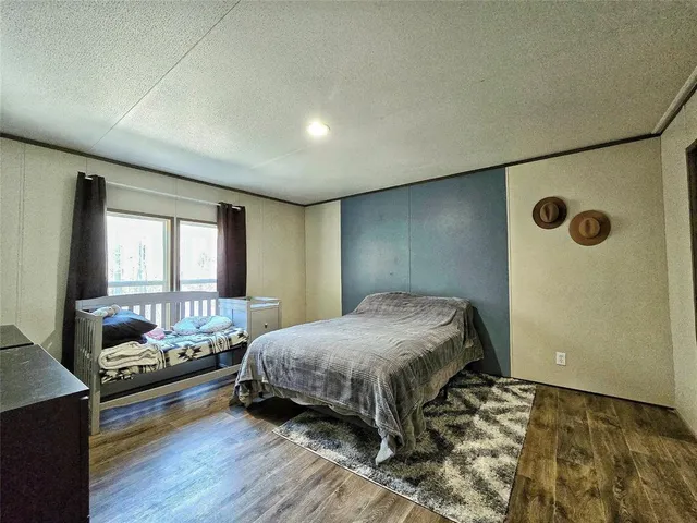 a bedroom with furniture and a wooden floor