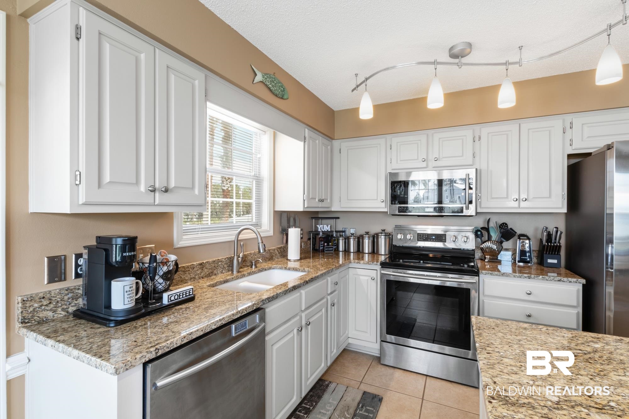 328 Windmill Ridge Road Gulf Shores, AL 36542 - Photo 10 of 47 Kitchen featuring appliances with stainless steel finishes, white cabinetry, and sink