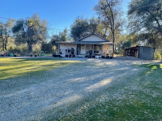 a front view of a house with swimming pool having outdoor seating