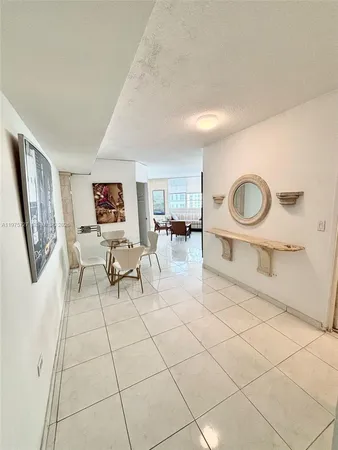 a living room with furniture a dining table and a painting on the wall