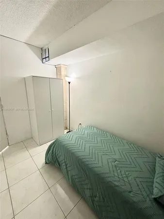 a bedroom with a bed and a shower