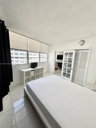 a bedroom with a bed furniture and a window