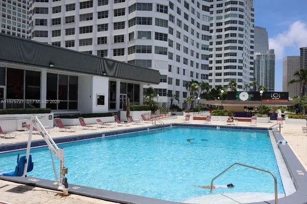 a view of a swimming pool with outdoor seating and yard