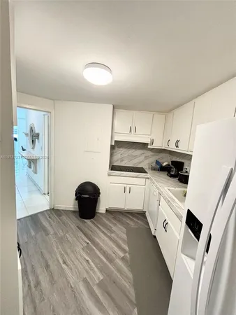 a kitchen with a sink and a stove top oven