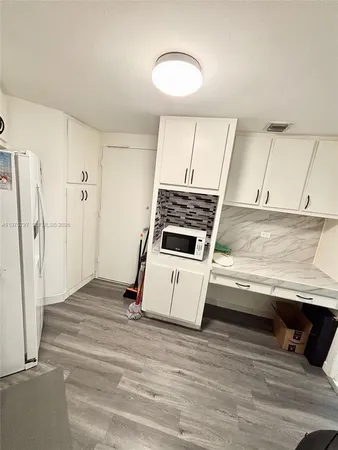 a view of kitchen and wooden floor