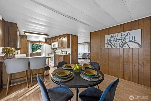 a view of a dining room with furniture and wooden floor
