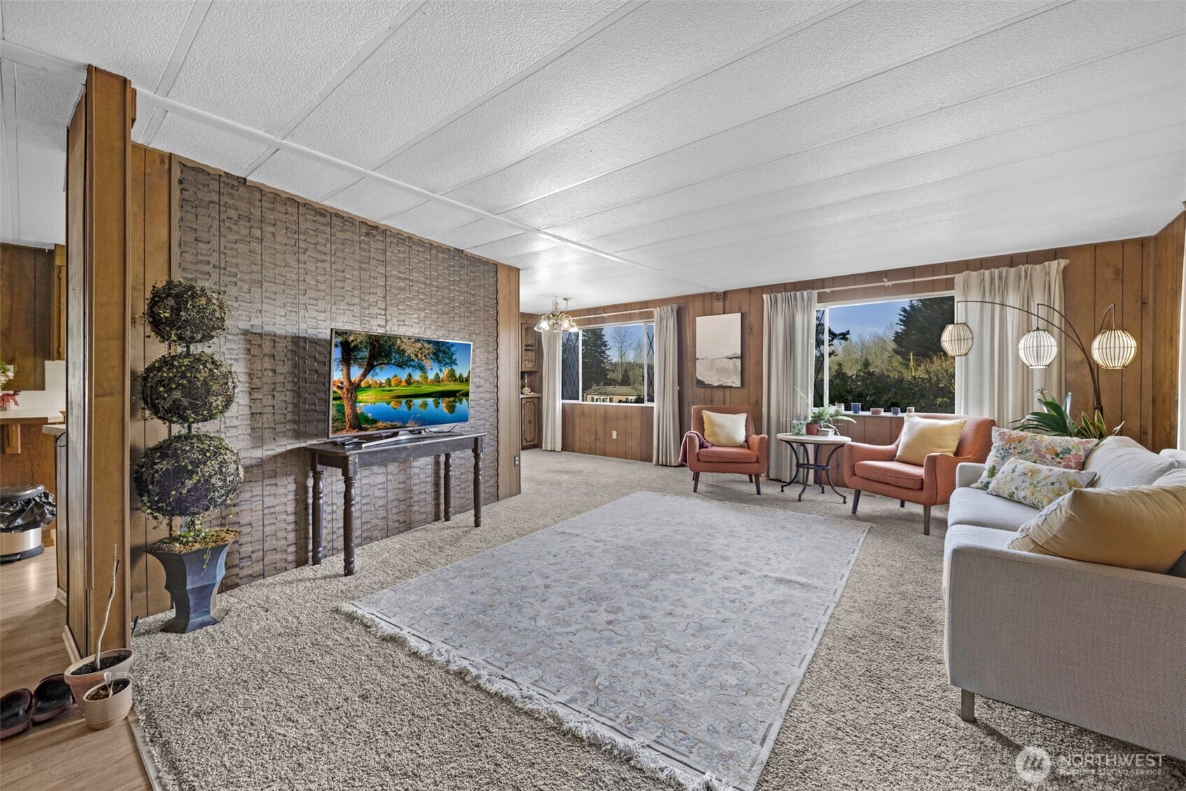 2200 196th Street Southeast, Unit 76 Bothell, WA 98012 - Photo 19 of 27 a living room with furniture and a flat screen tv