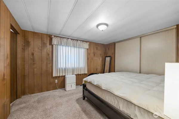 a bedroom with a large bed and a dresser