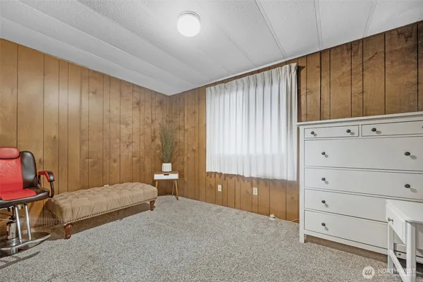 a spacious bedroom with a bed and a dresser