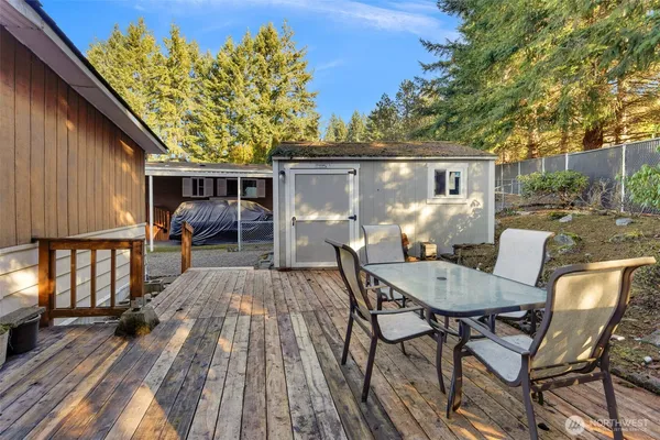a backyard of a house with table and chairs