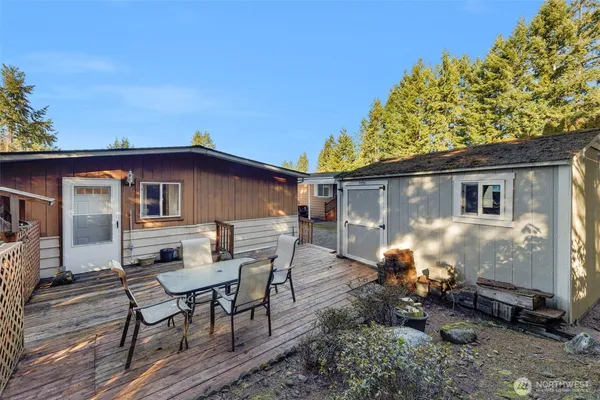 a backyard of a house with table and chairs