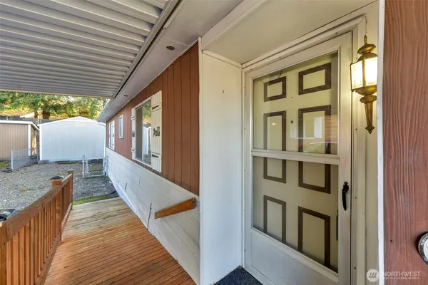 a view of balcony with wooden floor and outdoor seating