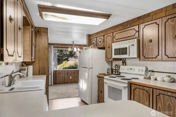 a kitchen with stainless steel appliances a refrigerator sink and cabinets