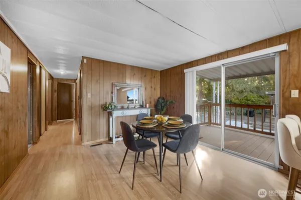 a dining room with furniture and wooden floor