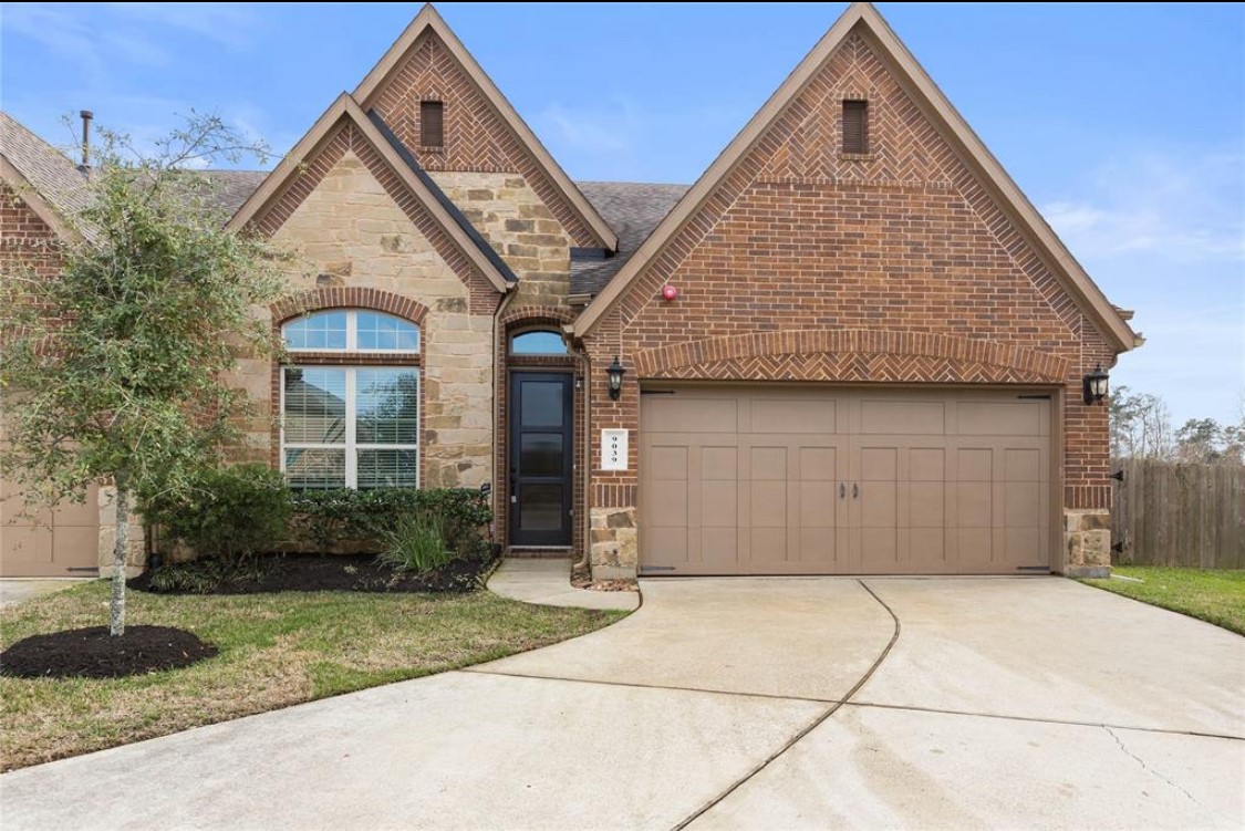 9039 Centennial Drive Conroe, TX 77384 - Photo 13 of 16 a front view of a house with garden