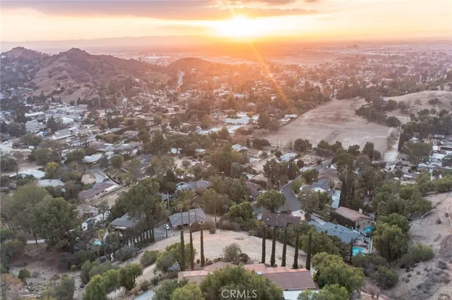 an aerial view of a houses with a yard