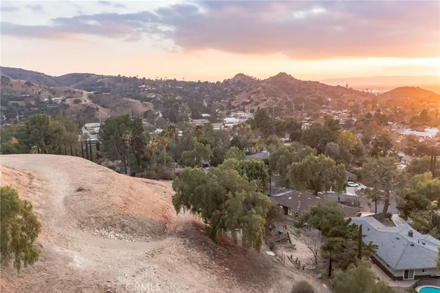 an aerial view of a house with a yard and greenery