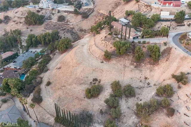 an aerial view of residential houses with city view
