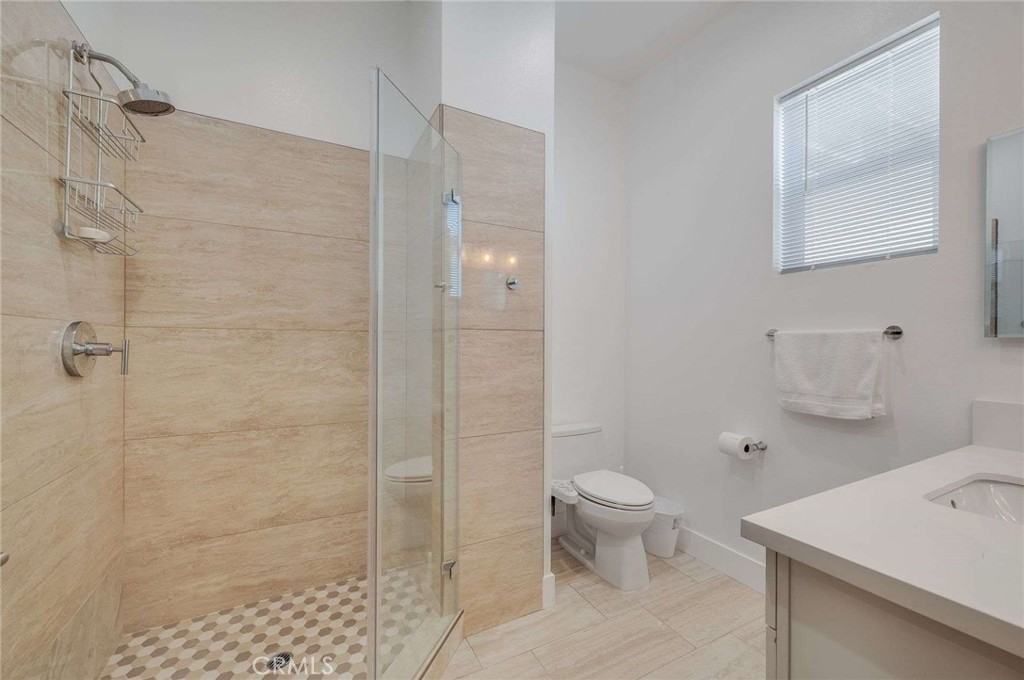 11837 Rideout Way Whittier, CA 90601 - Photo 30 of 44 a bathroom with a toilet sink and a shower