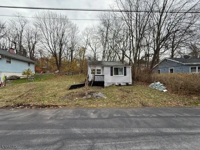 a view of a house with a yard covered with snow in front of house