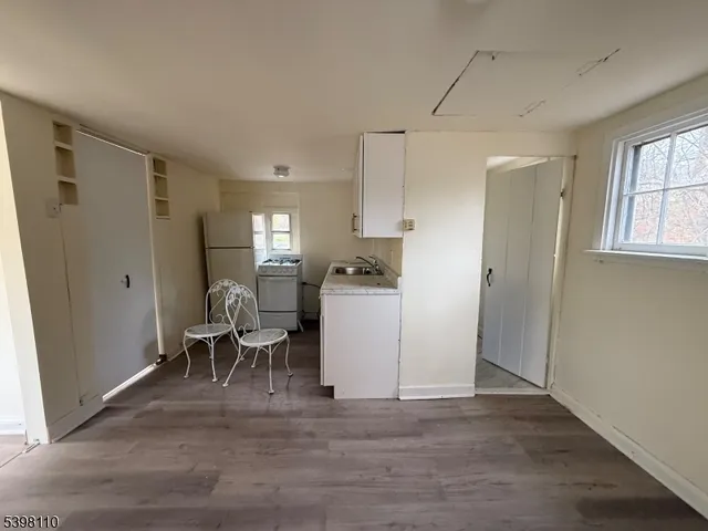 a kitchen with a refrigerator and a table