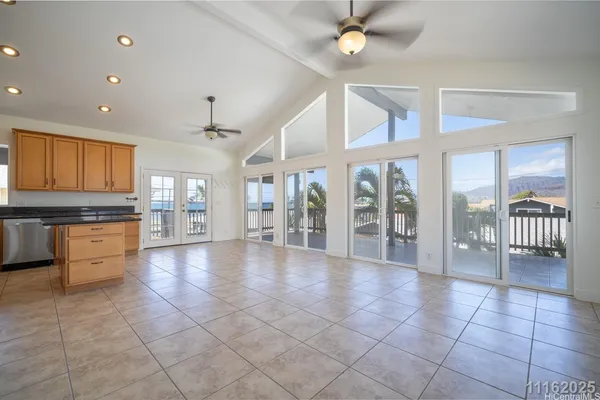 a large kitchen with granite countertop a large counter top stainless steel appliances and cabinets