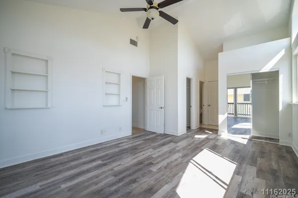 a view of a hallway with wooden floor