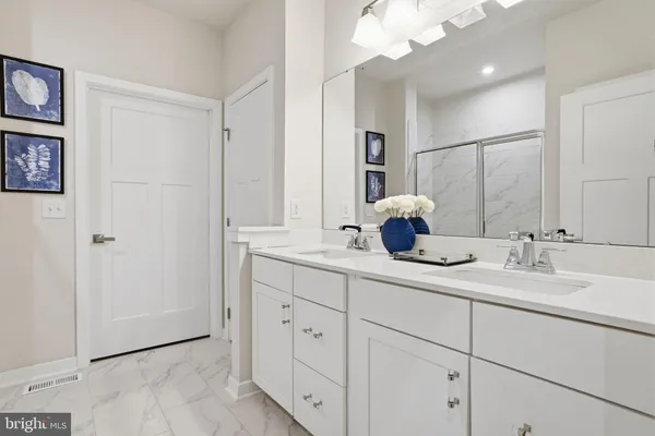 a bathroom with a double vanity sink and a mirror