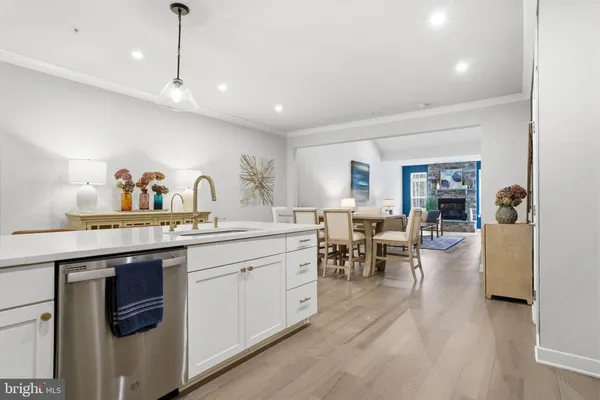 a kitchen with sink stove and cabinets