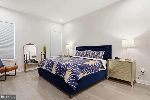 a bedroom with a bed and a lamp on table