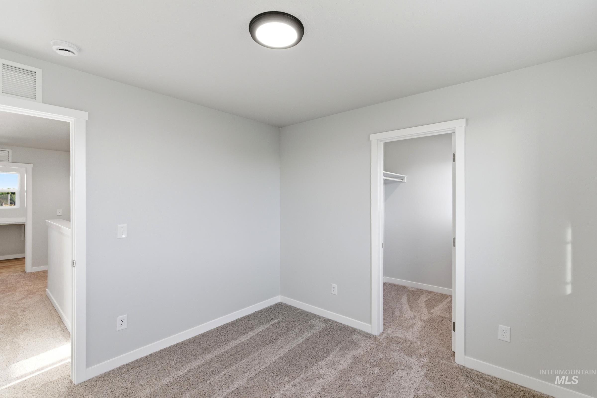 13709 Redway Court Caldwell, ID 83607 - Photo 19 of 28 Carpeted room featuring light gray walls, white baseboards, and a flush mount ceiling light fixture