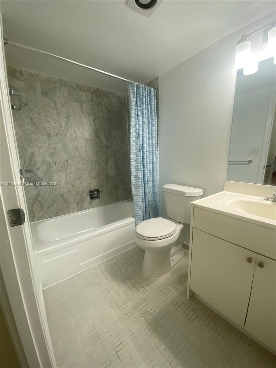 1625 Southeast 10th Avenue, Unit 205 Fort Lauderdale, FL 33316 - Photo 11 of 32 a white toilet sitting next to a bath tub
