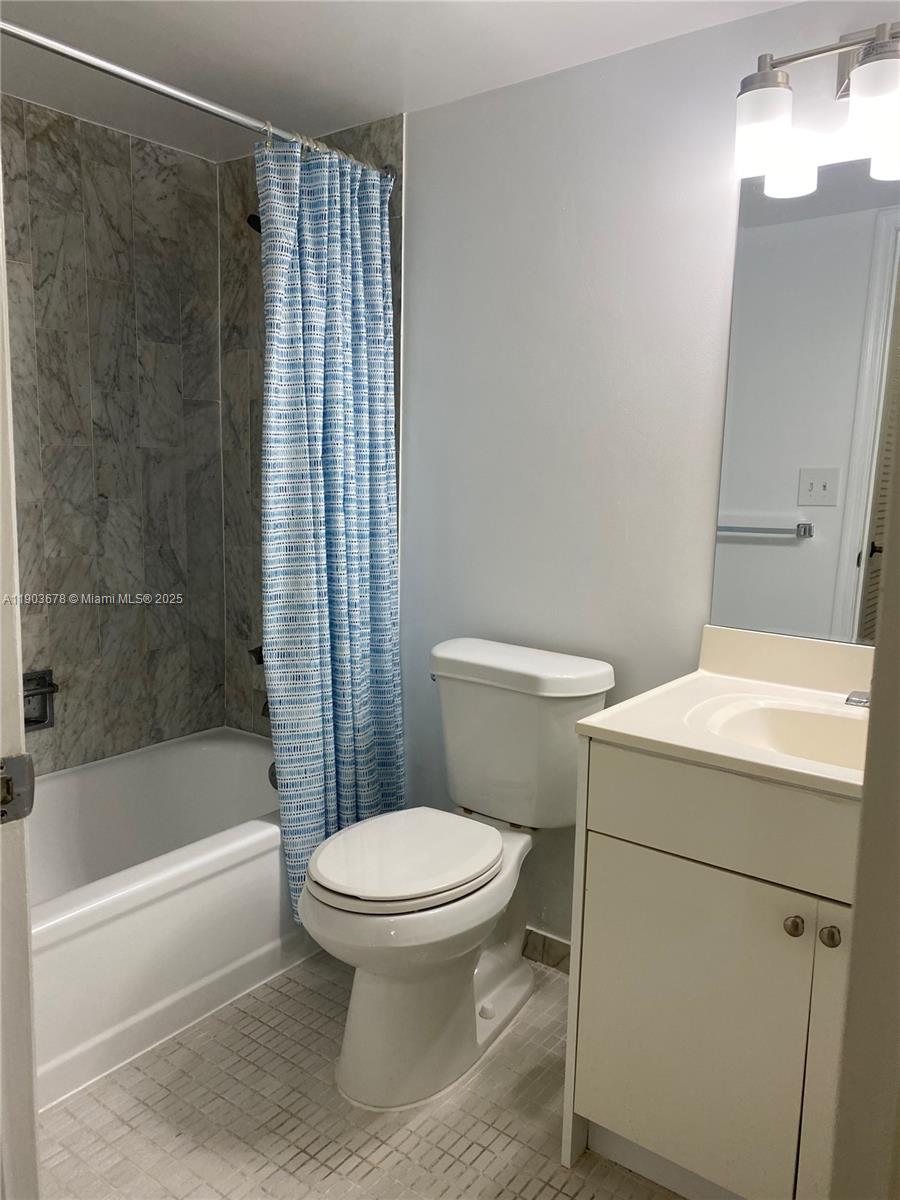 1625 Southeast 10th Avenue, Unit 205 Fort Lauderdale, FL 33316 - Photo 12 of 32 a white toilet sitting next to a bath tub