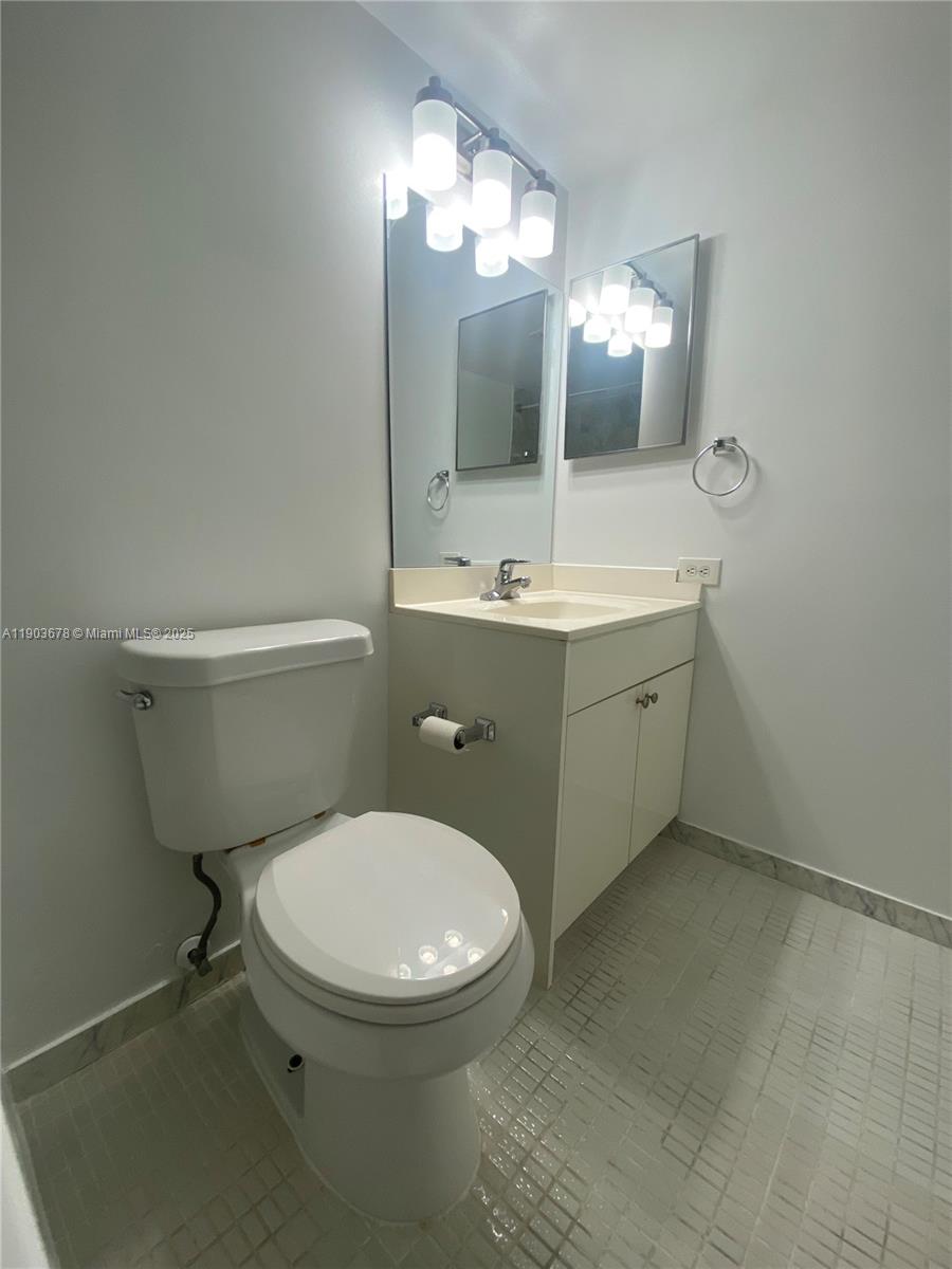 1625 Southeast 10th Avenue, Unit 205 Fort Lauderdale, FL 33316 - Photo 13 of 32 a bathroom with a toilet sink and mirror