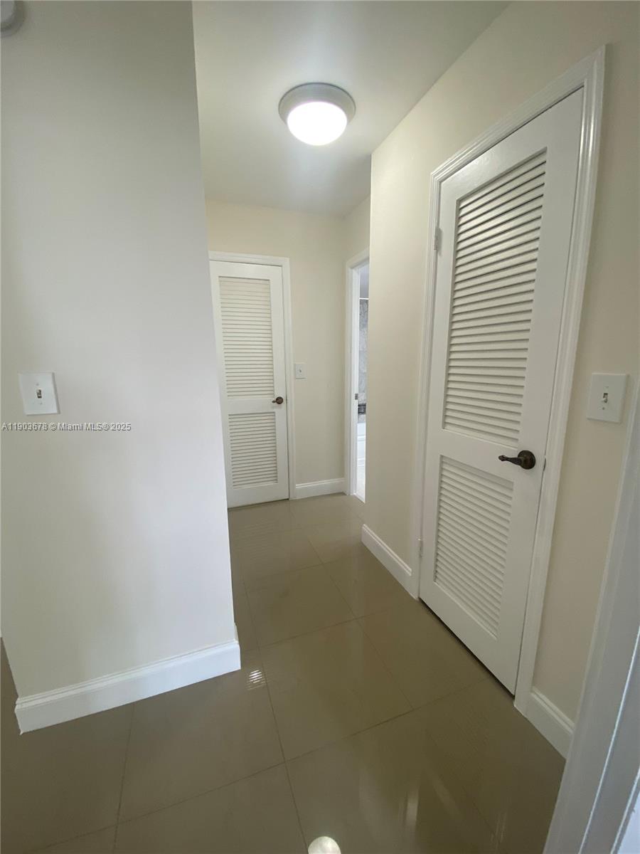 1625 Southeast 10th Avenue, Unit 205 Fort Lauderdale, FL 33316 - Photo 14 of 32 an empty room with a hallway
