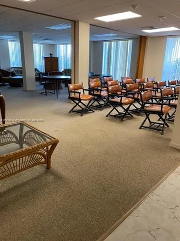 a sign that is sitting in front of a tree