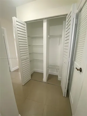 a white toilet sitting next to a bath tub