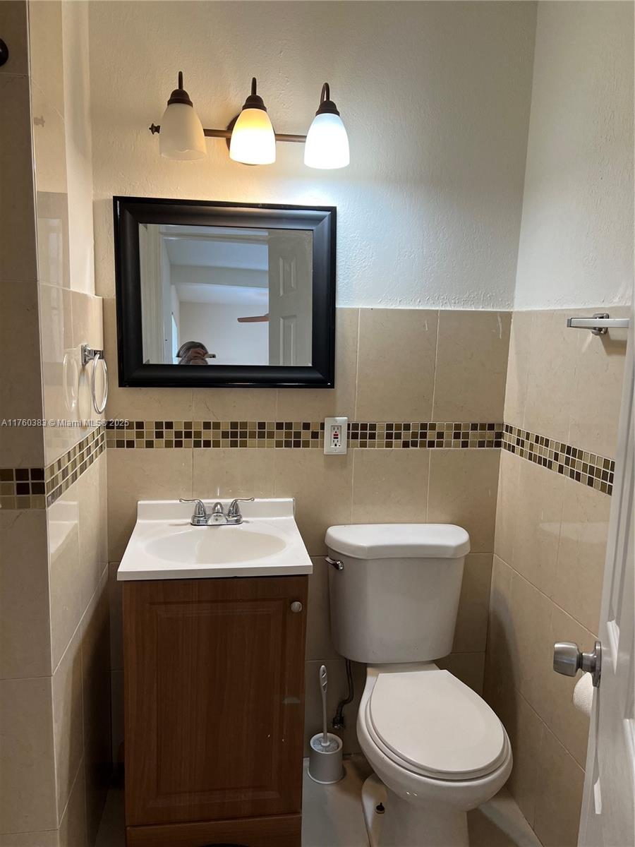 Dania Beach Dania Beach, FL 33312 - Photo 11 of 20 a bathroom with a toilet sink and mirror