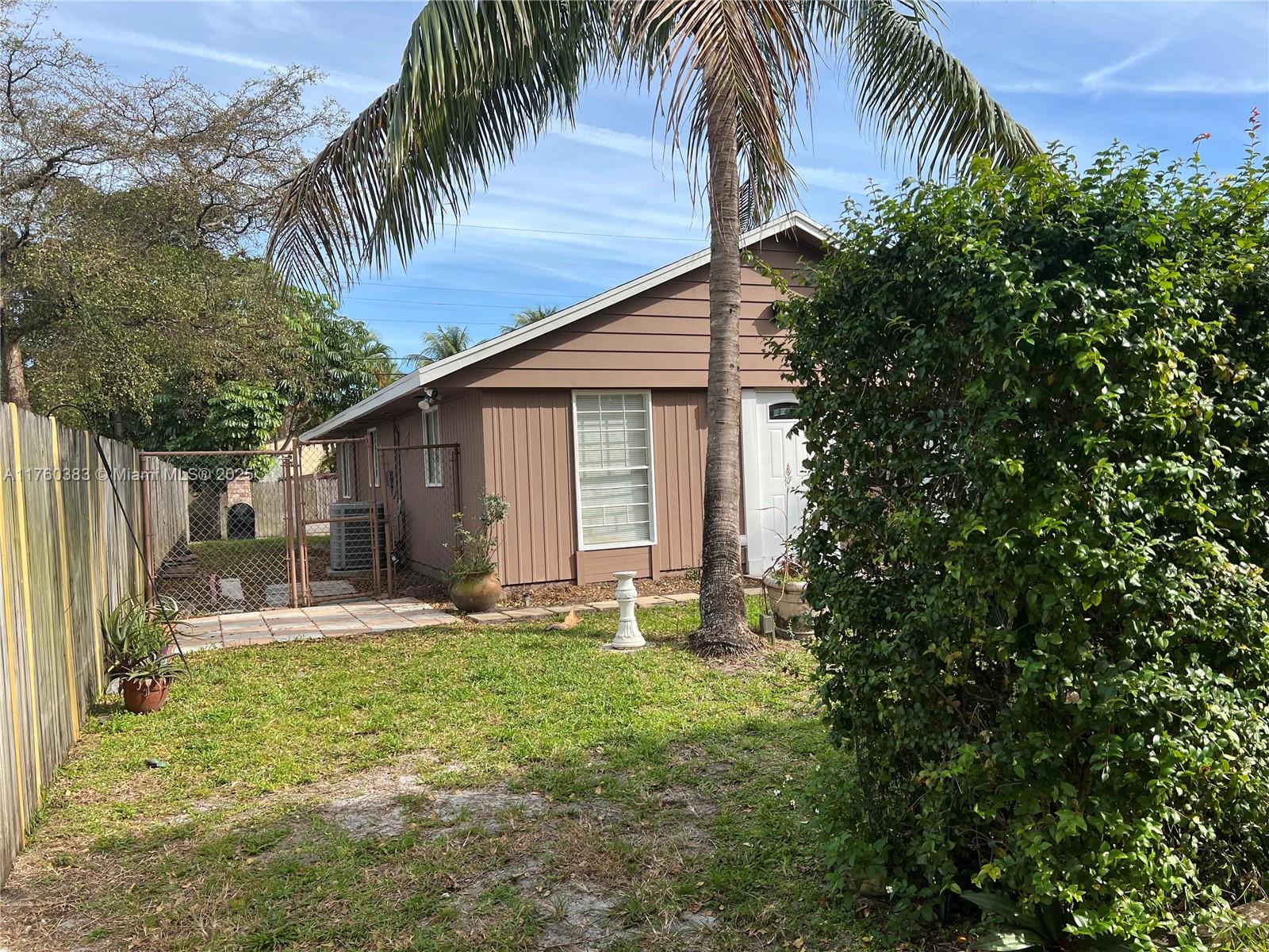 Dania Beach Dania Beach, FL 33312 - Photo 20 of 20 a backyard of a house with table and chairs